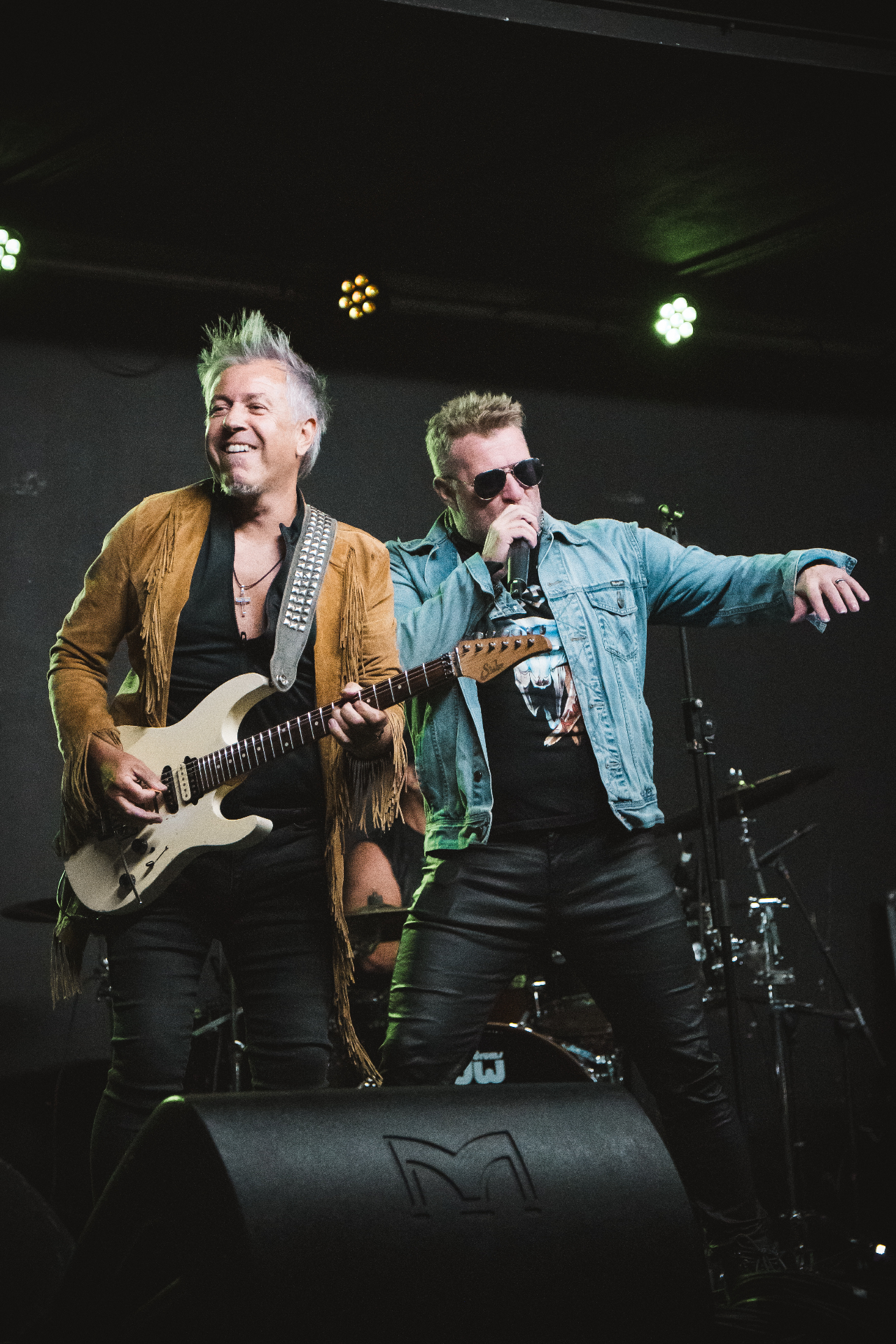 Guitarist and singer sharing the front of the stage