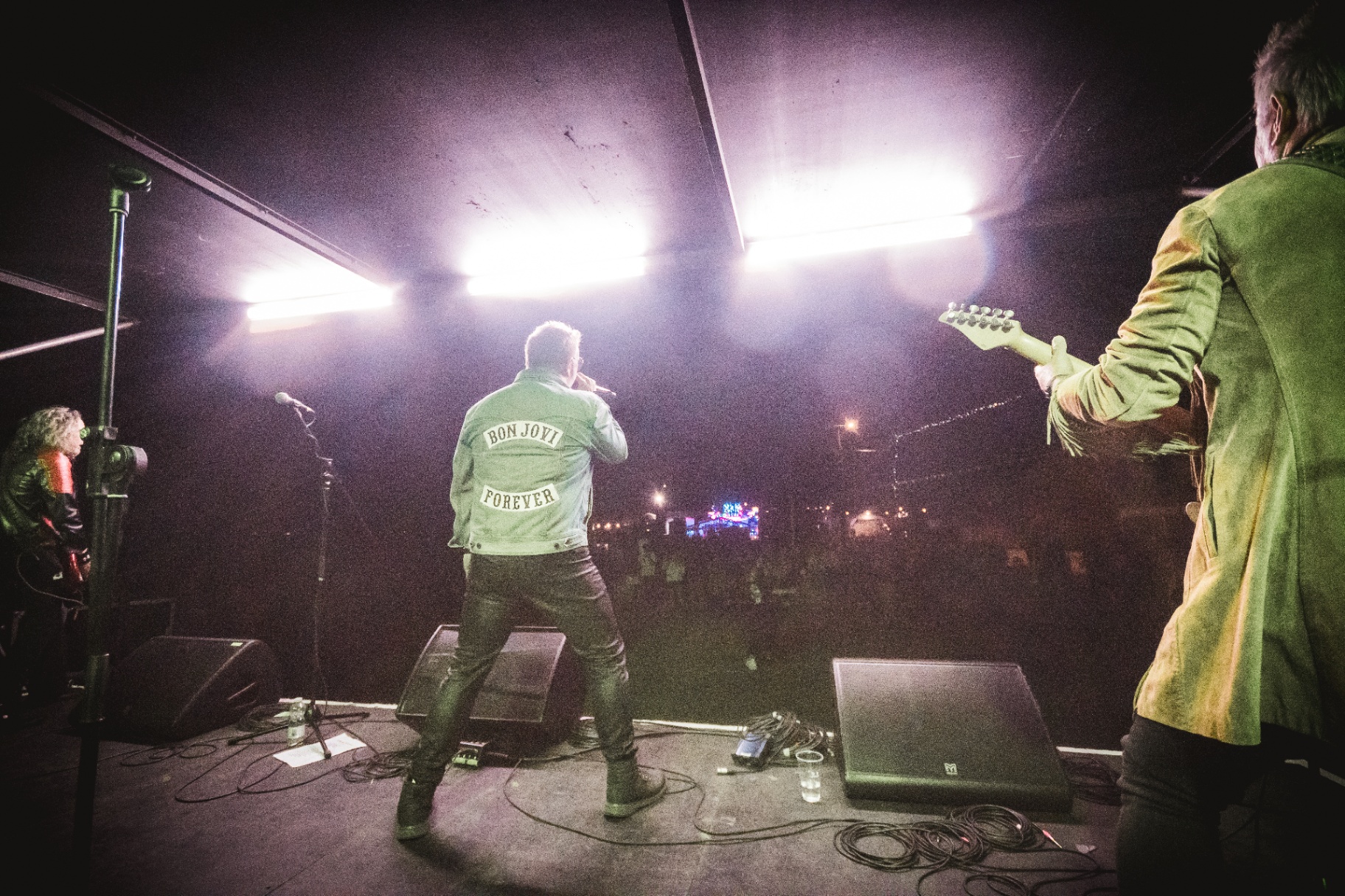 Legendary on stage facing the crowd under bright stage lights